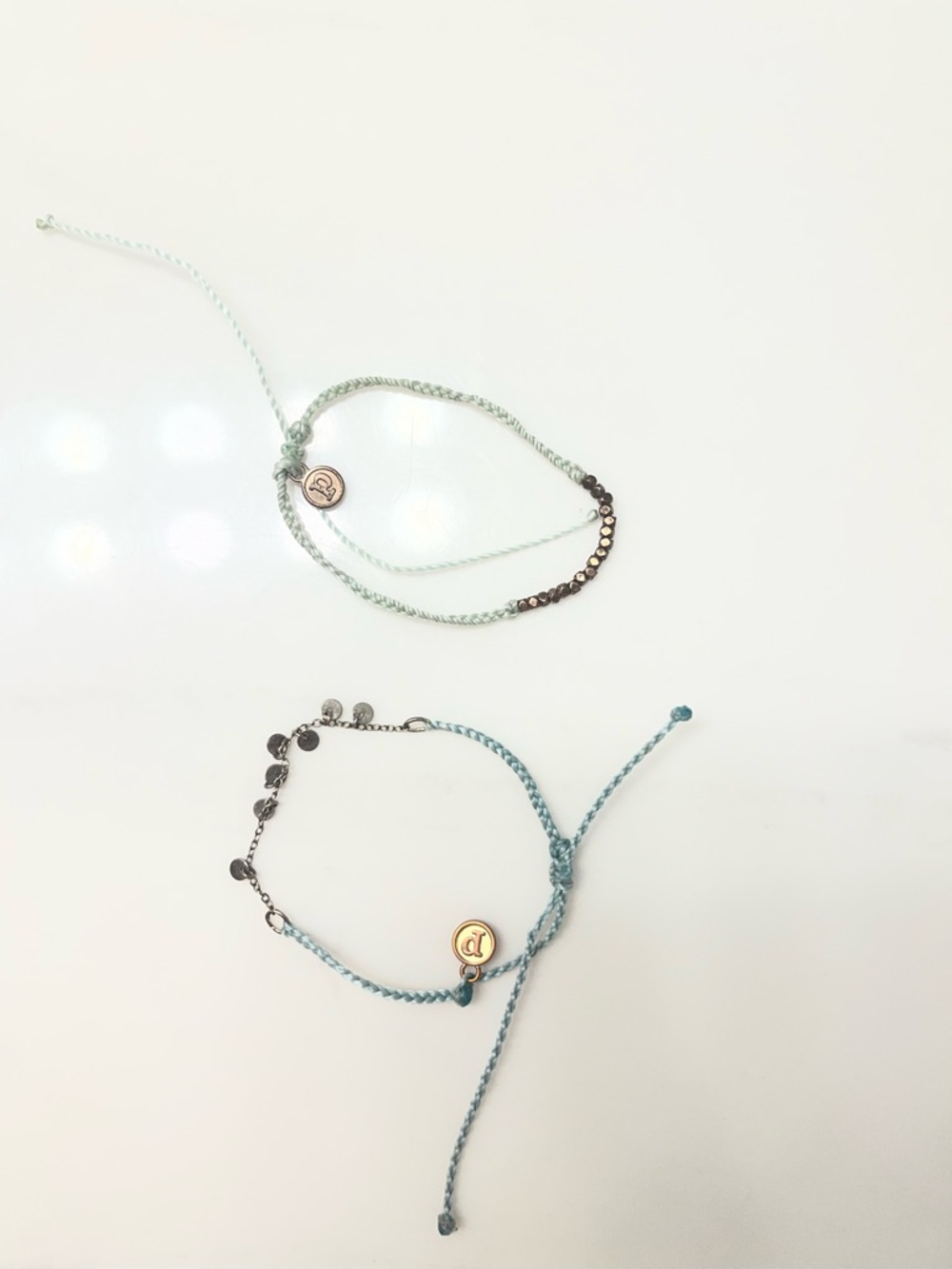 Two puravida bracelets have some discoloration but mostly in good condition.